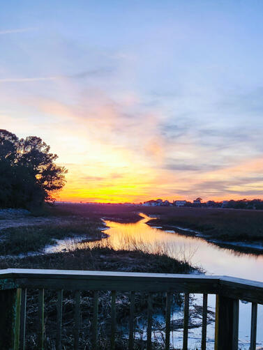 Sunset on the Crab Dock Golden sunset reflecting over Oak Creek with silhouetted trees and sky